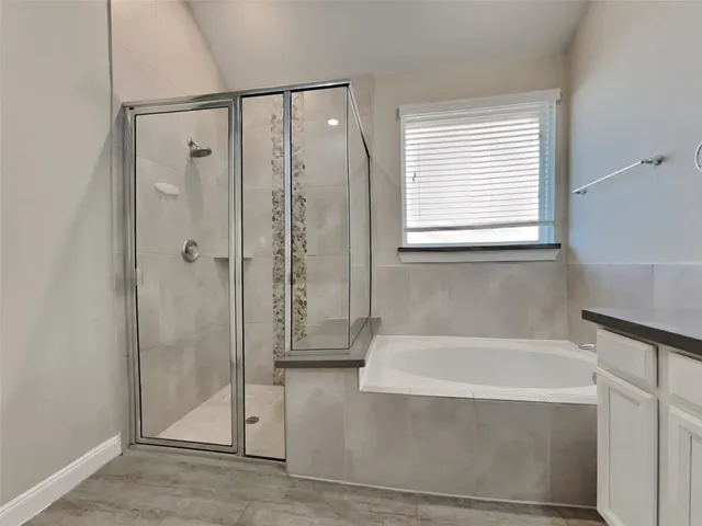 a bathroom with a bathtub and shower