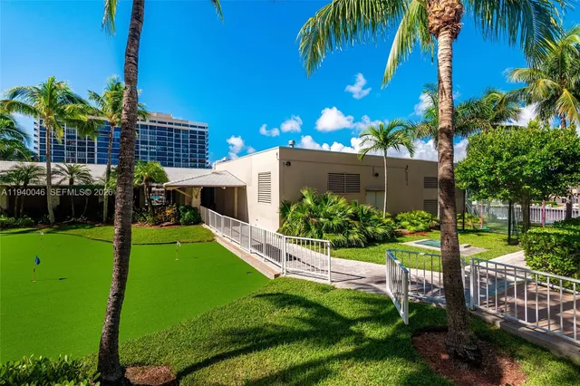 a view of a house with a yard and potted plants