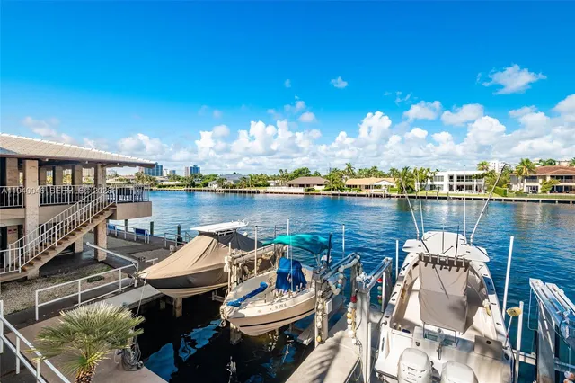 a view of a lake with couches chairs and city view