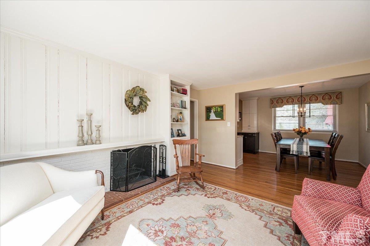 3426 Redbud Lane Raleigh, NC 27607 - Photo 16 of 30 a living room with furniture a rug and a fireplace