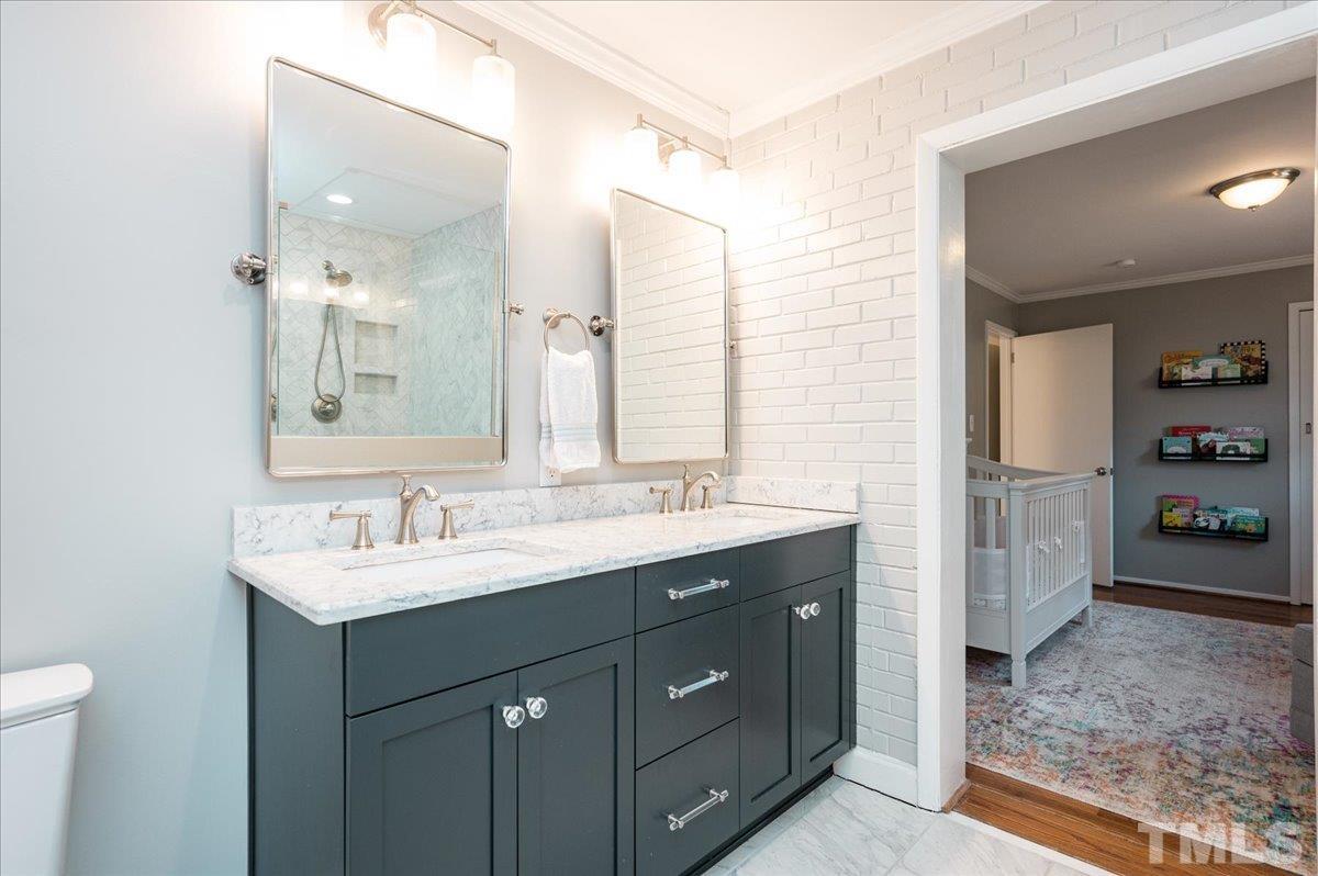 3426 Redbud Lane Raleigh, NC 27607 - Photo 18 of 30 a bathroom with a sink double vanity and a mirror