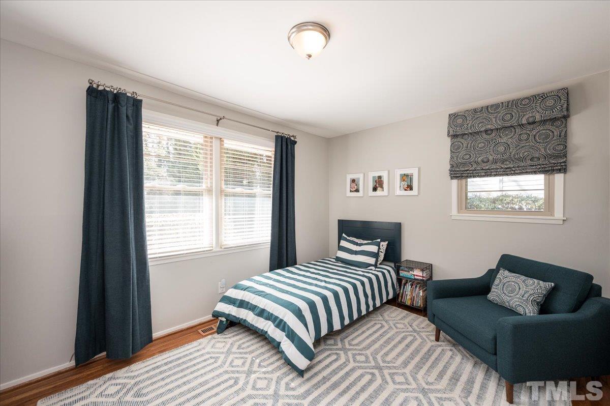 3426 Redbud Lane Raleigh, NC 27607 - Photo 21 of 30 a bedroom with a bed and a couch