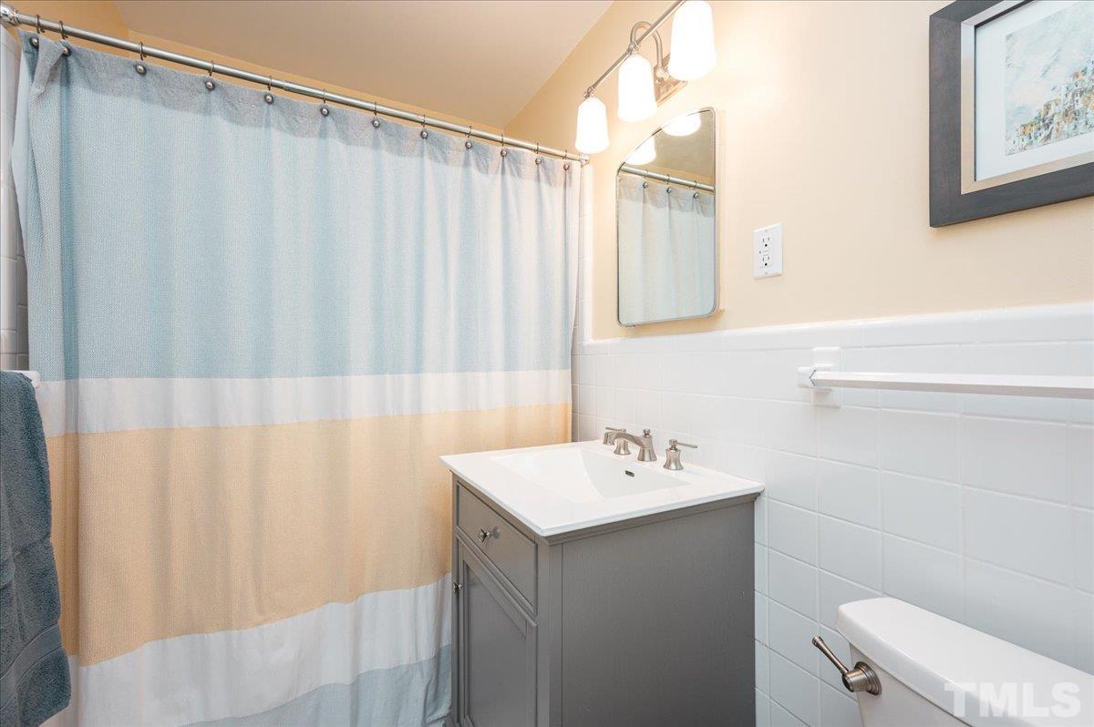 3426 Redbud Lane Raleigh, NC 27607 - Photo 22 of 30 a bathroom with a sink a toilet and a mirror