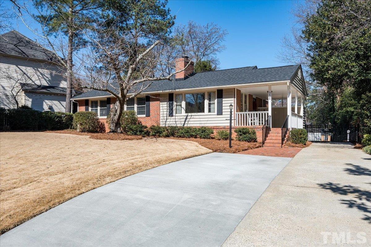 3426 Redbud Lane Raleigh, NC 27607 - Photo 3 of 30 a front view of a house with a yard