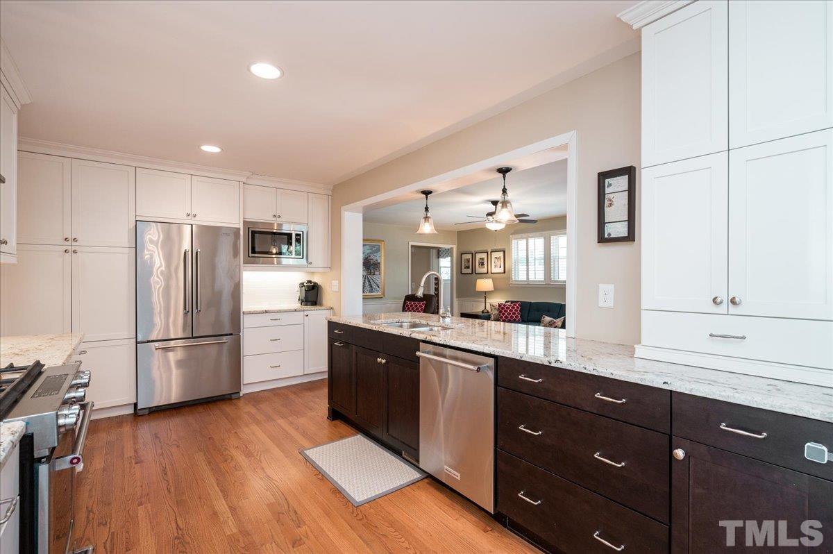 3426 Redbud Lane Raleigh, NC 27607 - Photo 7 of 30 a kitchen with a refrigerator a sink and dishwasher