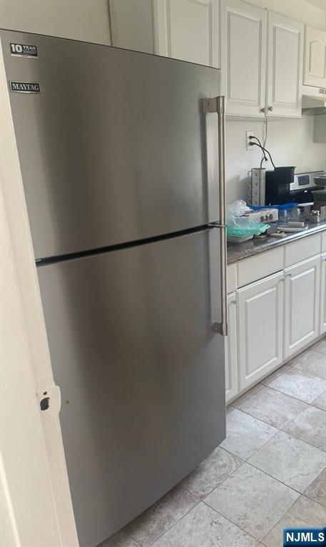 1480 Terrace, Unit 4 Teaneck, NJ 07666 - Photo 12 of 14 a white refrigerator freezer sitting in a kitchen