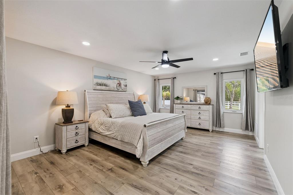 1908 Poppy Lane Port Orange, FL 32128 - Photo 13 of 43 a bedroom with a large bed and a view of kitchen