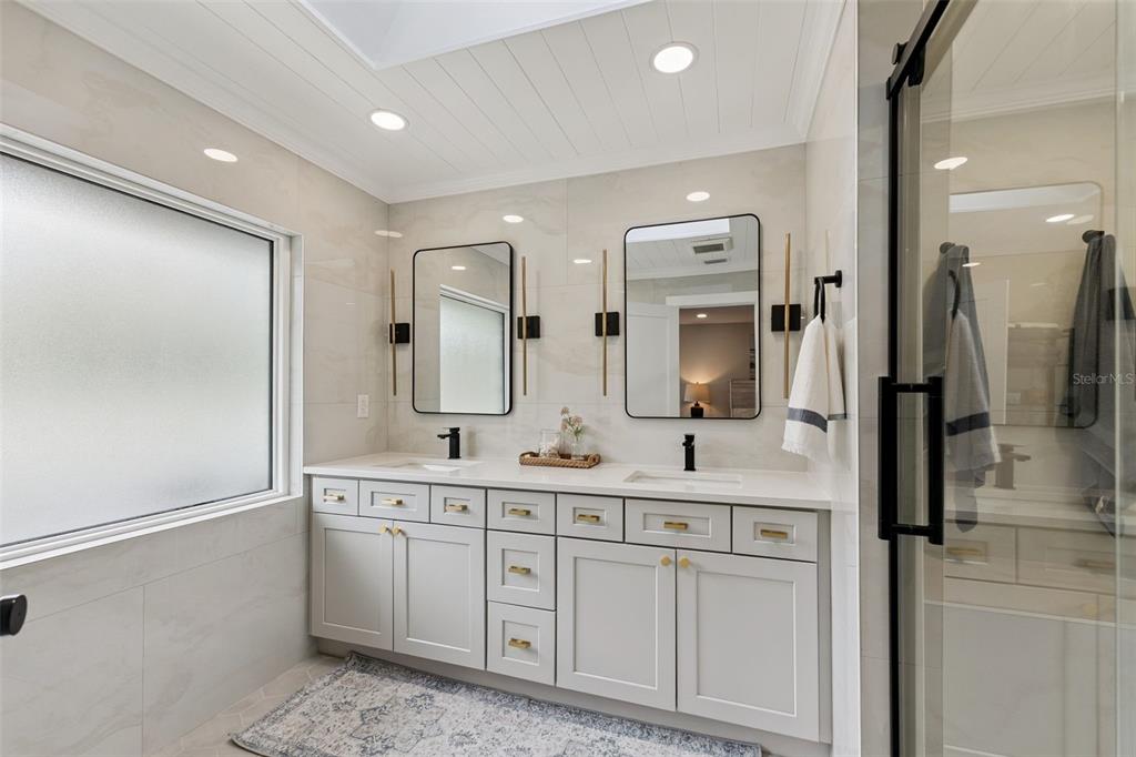 1908 Poppy Lane Port Orange, FL 32128 - Photo 16 of 43 a spacious bathroom with double vanity and mirrors