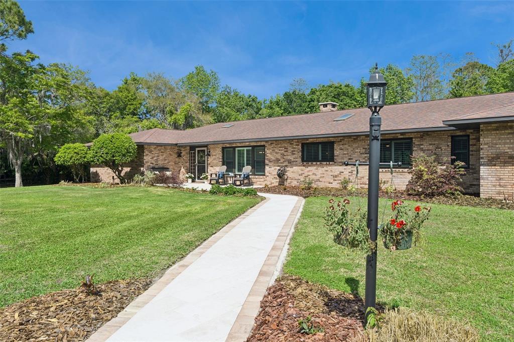 1908 Poppy Lane Port Orange, FL 32128 - Photo 2 of 43 a front view of a house with garden