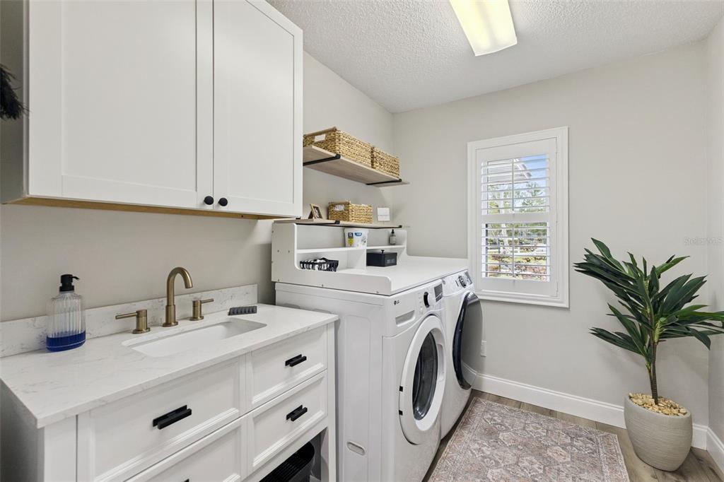 1908 Poppy Lane Port Orange, FL 32128 - Photo 26 of 43 a view of kitchen sink and a washer dryer