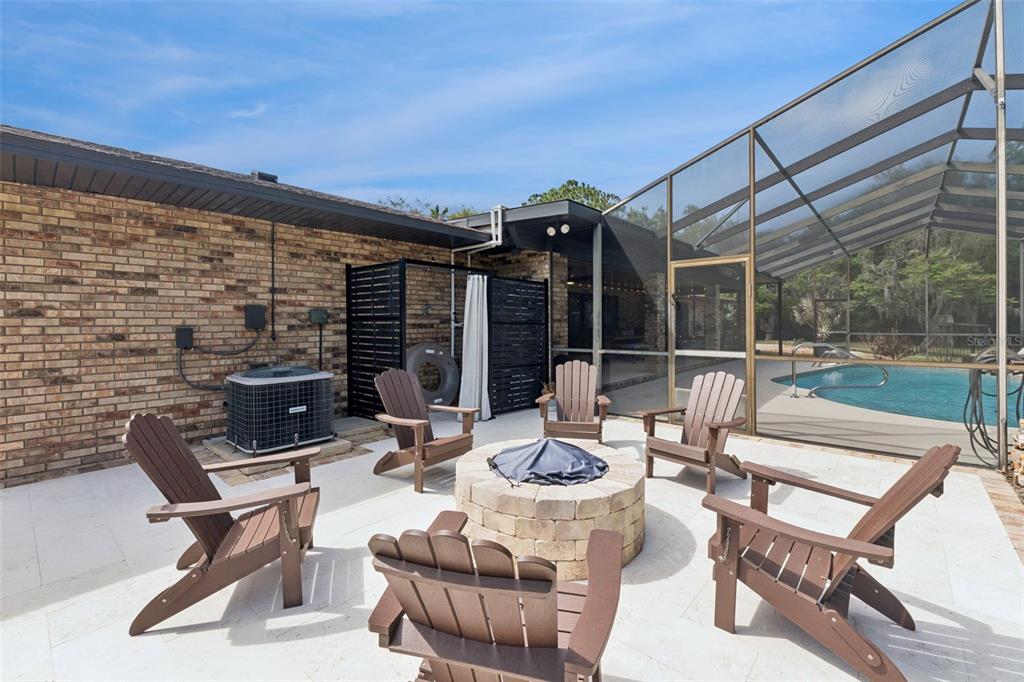1908 Poppy Lane Port Orange, FL 32128 - Photo 31 of 43 a view of a patio with a dining table and chairs