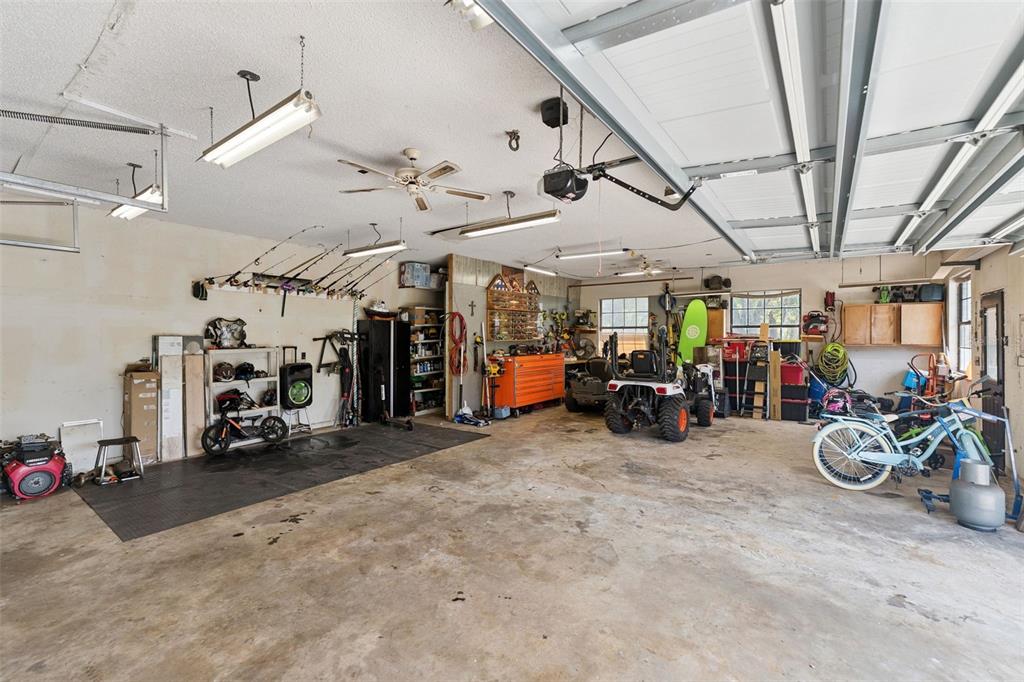 1908 Poppy Lane Port Orange, FL 32128 - Photo 33 of 43 a view of a garage with a bike and white car