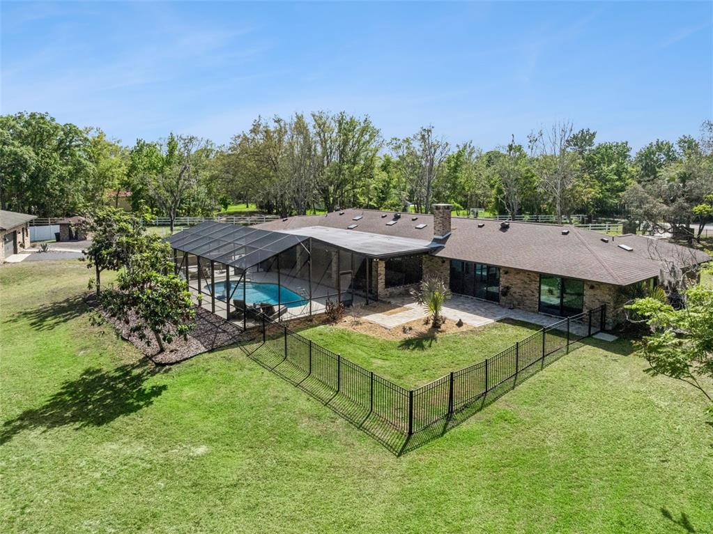 1908 Poppy Lane Port Orange, FL 32128 - Photo 34 of 43 a view of a house with backyard patio and outdoor kitchen