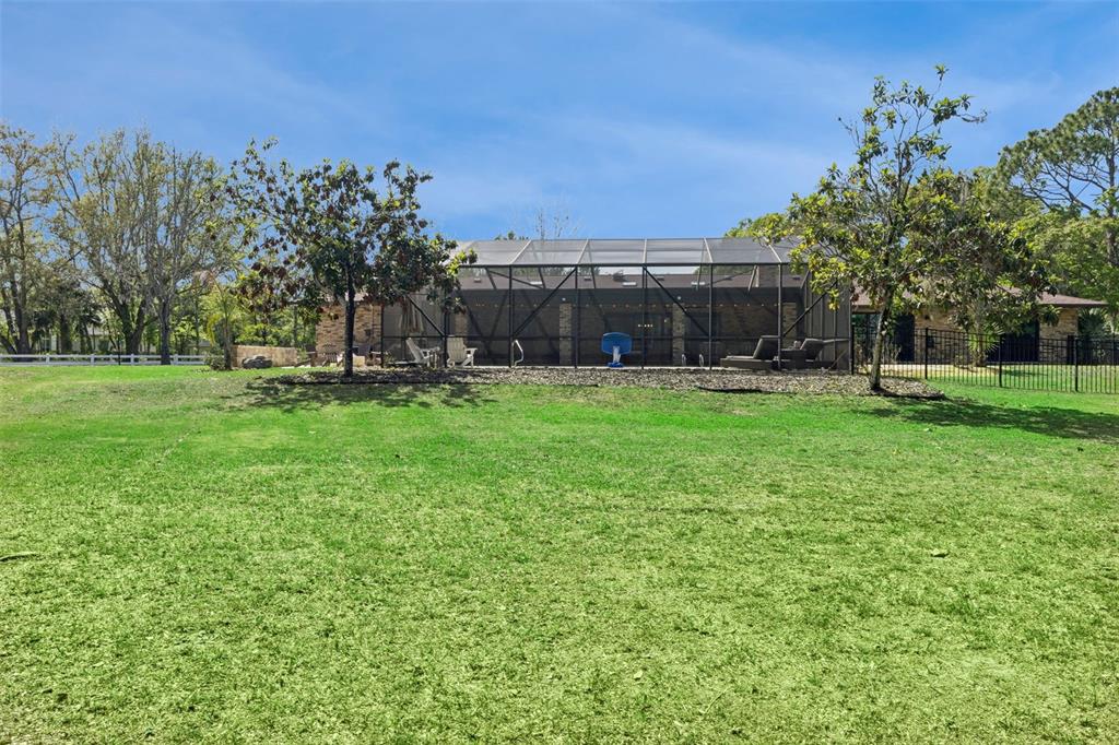 1908 Poppy Lane Port Orange, FL 32128 - Photo 36 of 43 a view of a backyard with a garden and trees