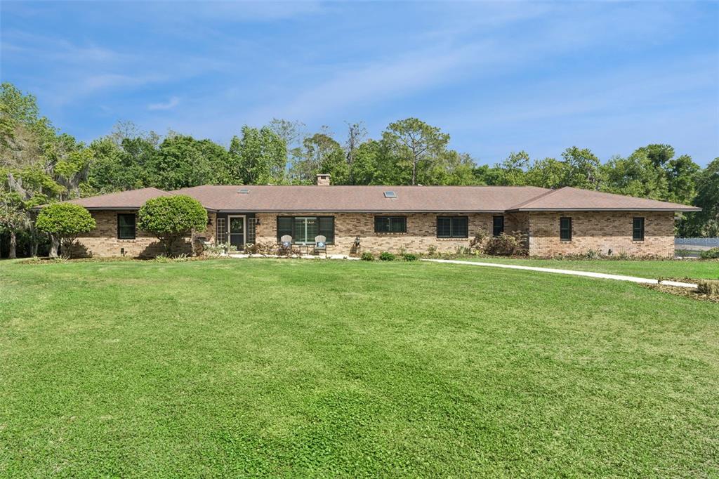 1908 Poppy Lane Port Orange, FL 32128 - Photo 39 of 43 a front view of a house with a yard table and chairs