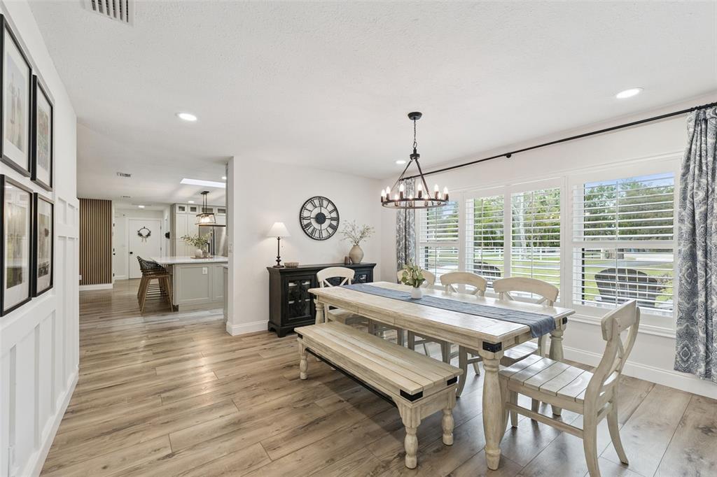 1908 Poppy Lane Port Orange, FL 32128 - Photo 6 of 43 a view of a dining room and livingroom with furniture wooden floor a chandelier