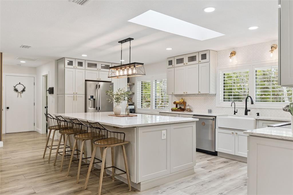 1908 Poppy Lane Port Orange, FL 32128 - Photo 8 of 43 a kitchen with stainless steel appliances a sink a stove a refrigerator and island with wooden floor