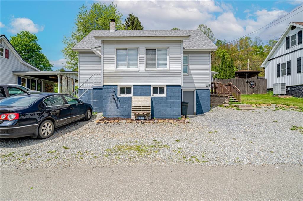135 Elrico Road Slickville, PA 15684 - Photo 1 of 22 a car parked in front of a house