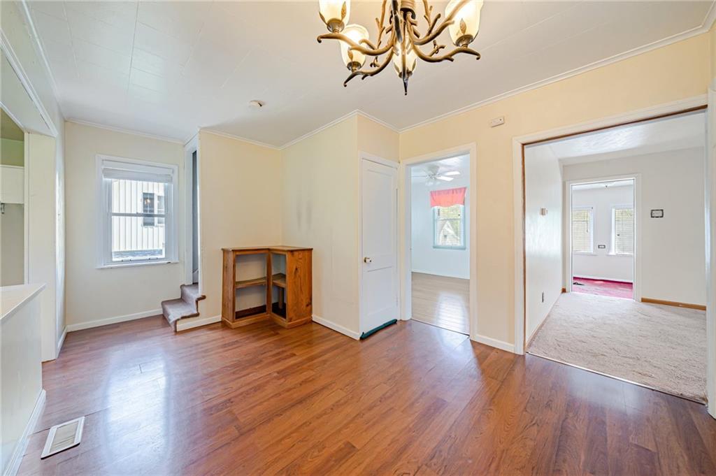 135 Elrico Road Slickville, PA 15684 - Photo 11 of 22 a view of a livingroom with wooden floor and a fireplace