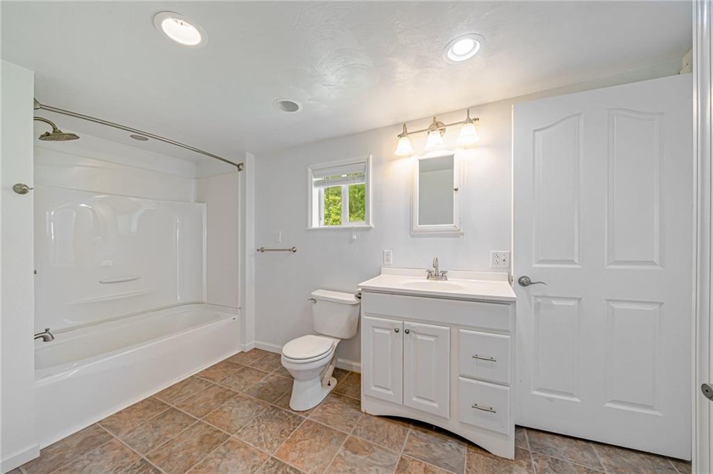 135 Elrico Road Slickville, PA 15684 - Photo 14 of 22 a bathroom with a granite countertop sink a toilet and shower