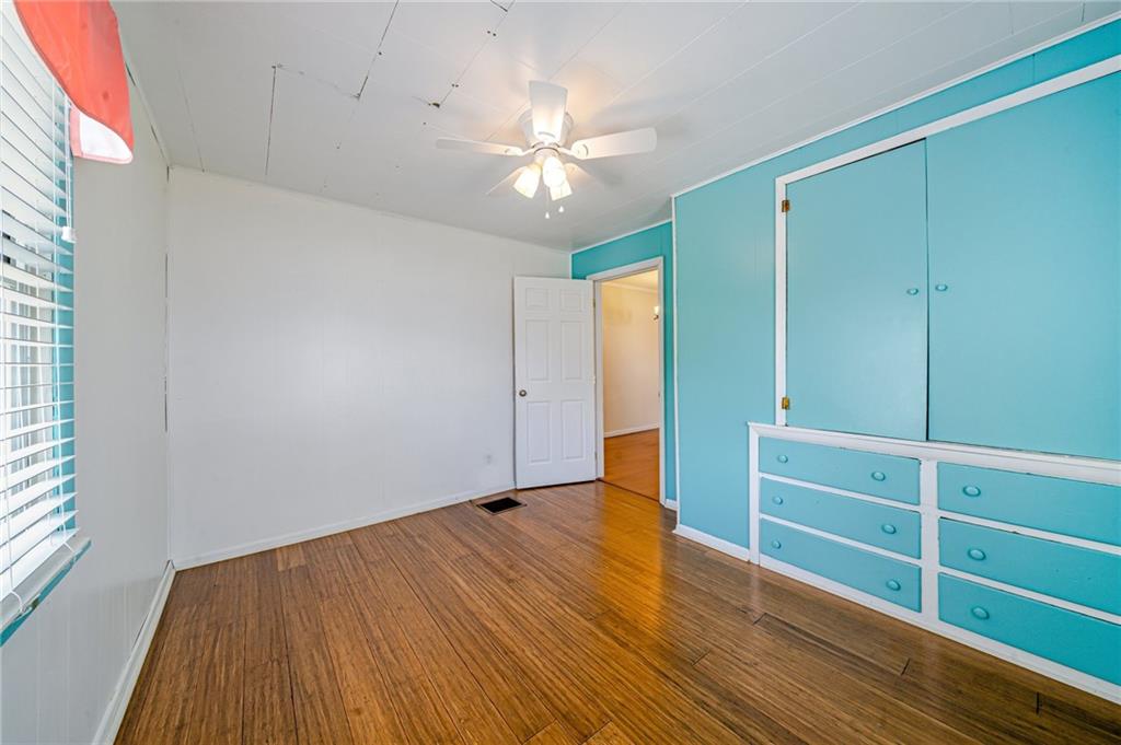 135 Elrico Road Slickville, PA 15684 - Photo 16 of 22 an empty room with wooden floor closet and windows