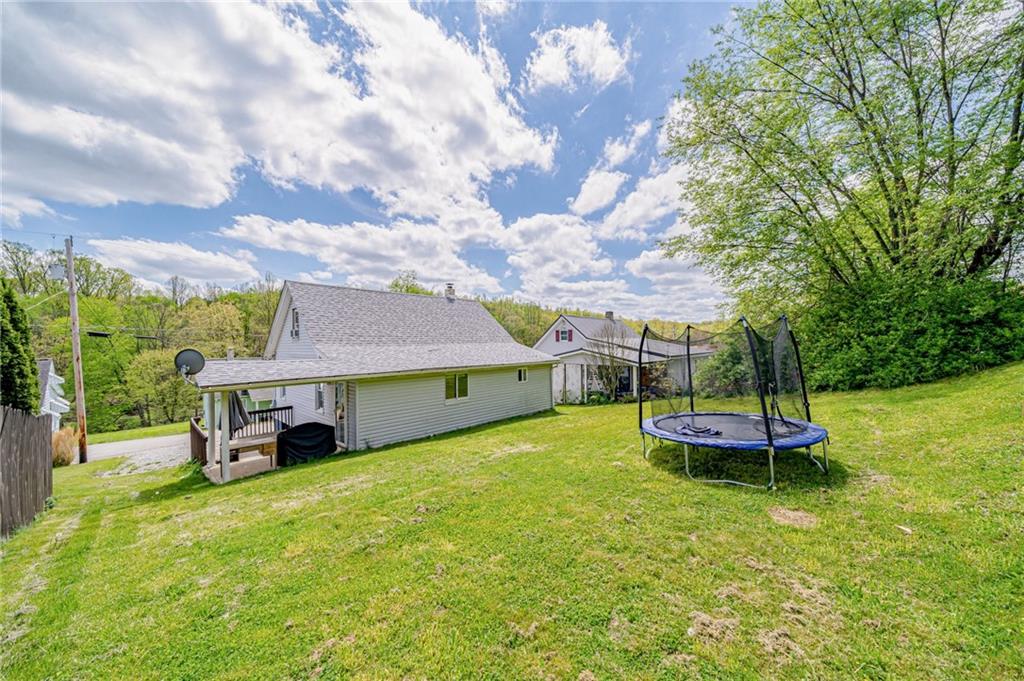 135 Elrico Road Slickville, PA 15684 - Photo 19 of 22 a yellow house with trees in front of it