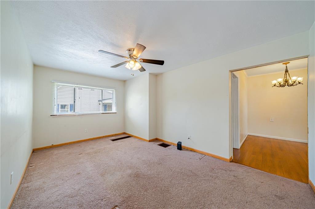 135 Elrico Road Slickville, PA 15684 - Photo 3 of 22 an empty room with windows and fan