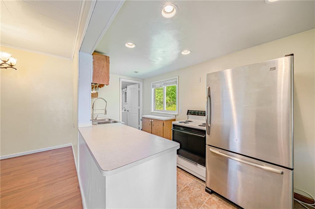 135 Elrico Road Slickville, PA 15684 - Photo 6 of 22 a kitchen with stainless steel appliances a refrigerator sink and stove