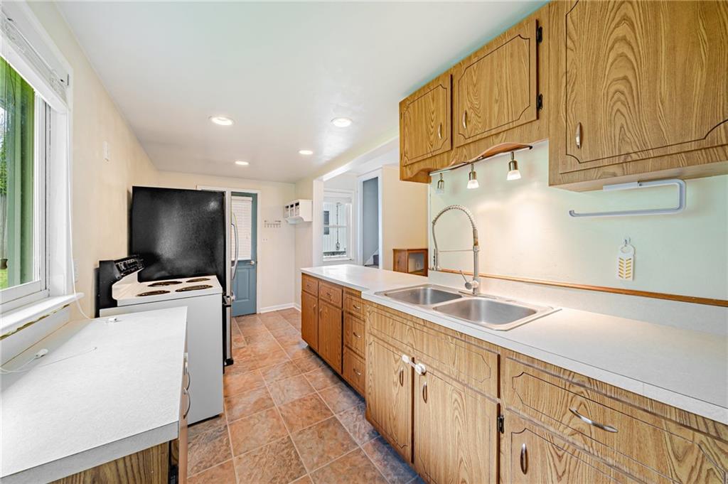 135 Elrico Road Slickville, PA 15684 - Photo 7 of 22 a kitchen with cabinets a sink and a stove
