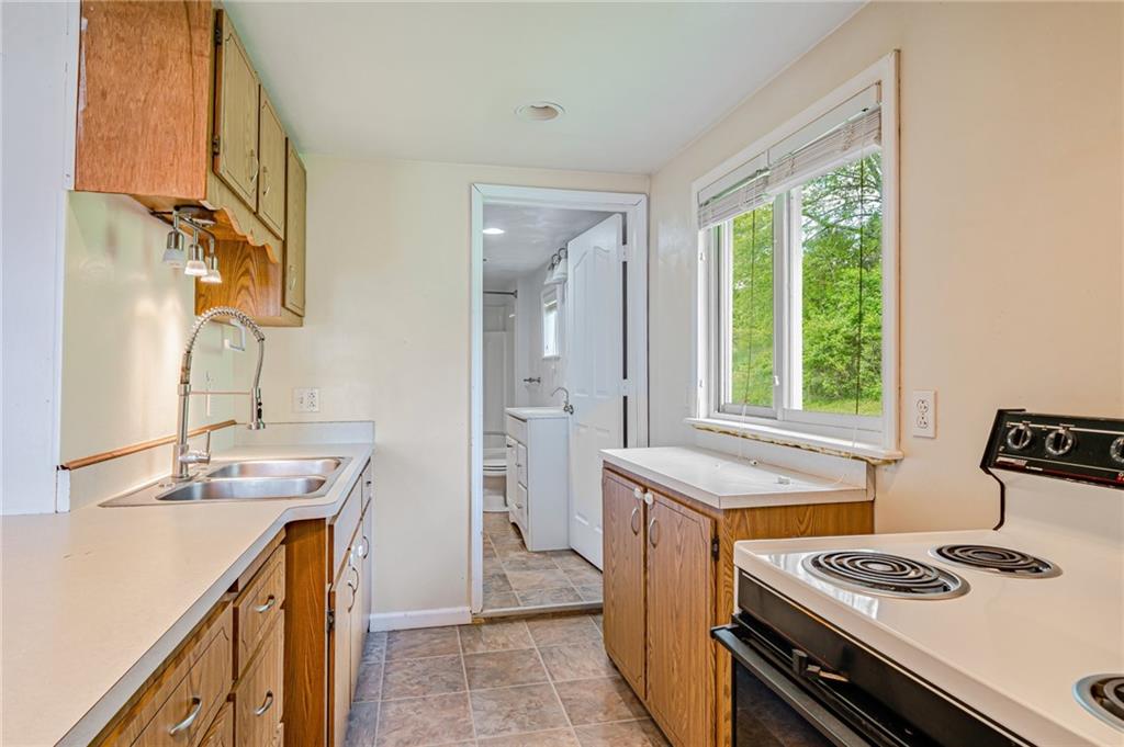 135 Elrico Road Slickville, PA 15684 - Photo 8 of 22 a kitchen with a sink stove and cabinets