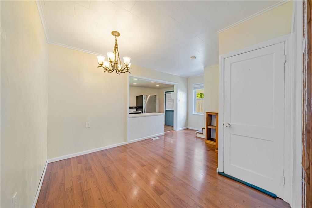 135 Elrico Road Slickville, PA 15684 - Photo 10 of 22 a view of a room with wooden floor staircase and a kitchen space