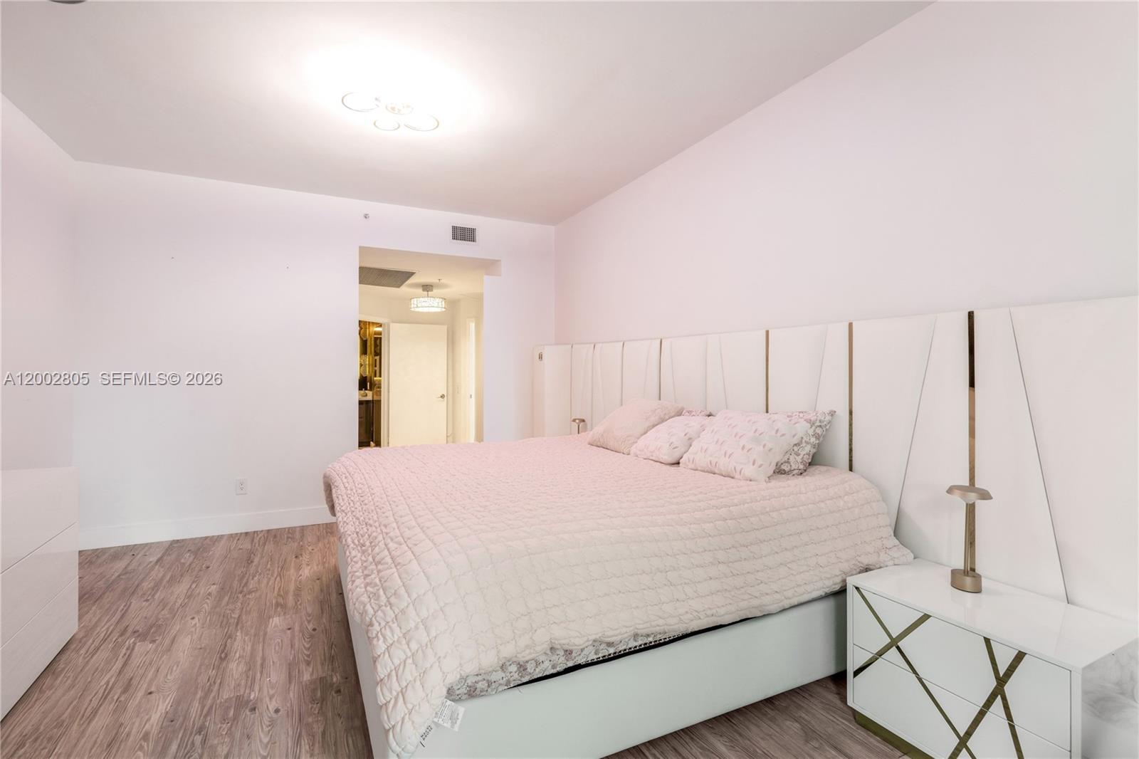 60 Southwest 13th Street, Unit 1124 Miami, FL 33130 - Photo 12 of 30 a bedroom with a bed and a table