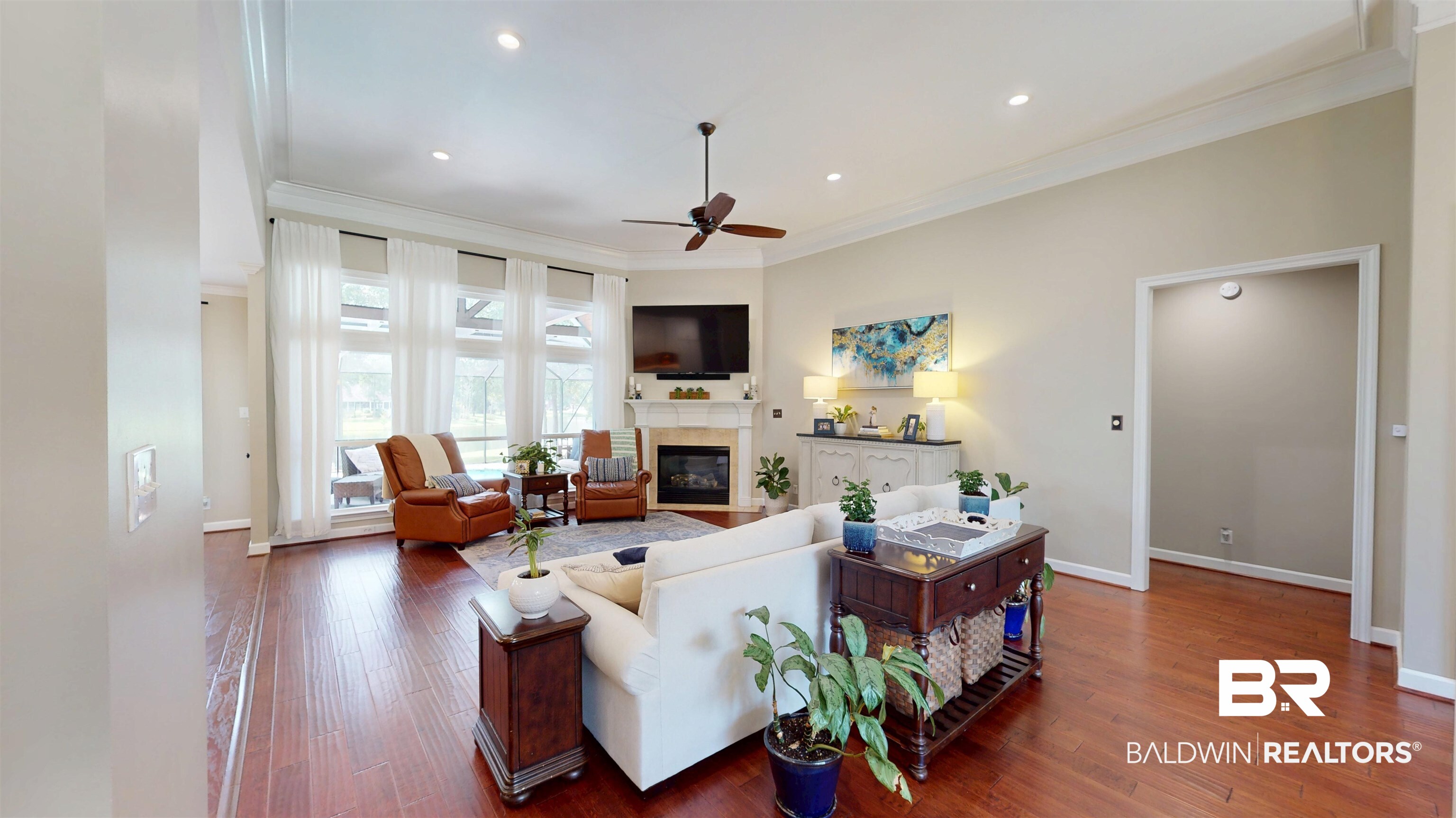 8775 Dawes Lake Road North Mobile, AL 36619 - Photo 19 of 59 Living area with a ceiling fan, hardwood / wood-style floors, a glass covered fireplace, crown molding, and recessed lighting