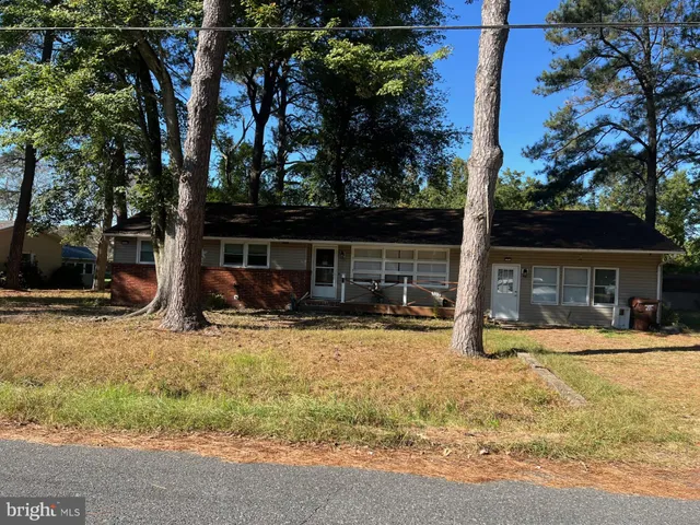 a view of a house with backyard porch and sitting area