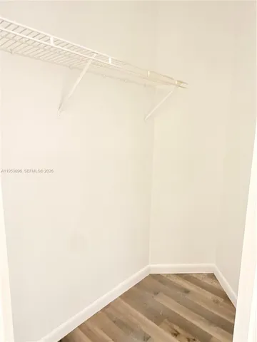 a view of a room with wooden floor and window