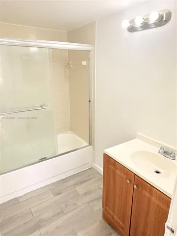 a view of a room with wooden floor