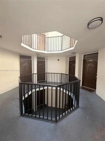 a view of staircase with white walls and windows