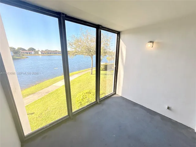 a view of an empty room and a window