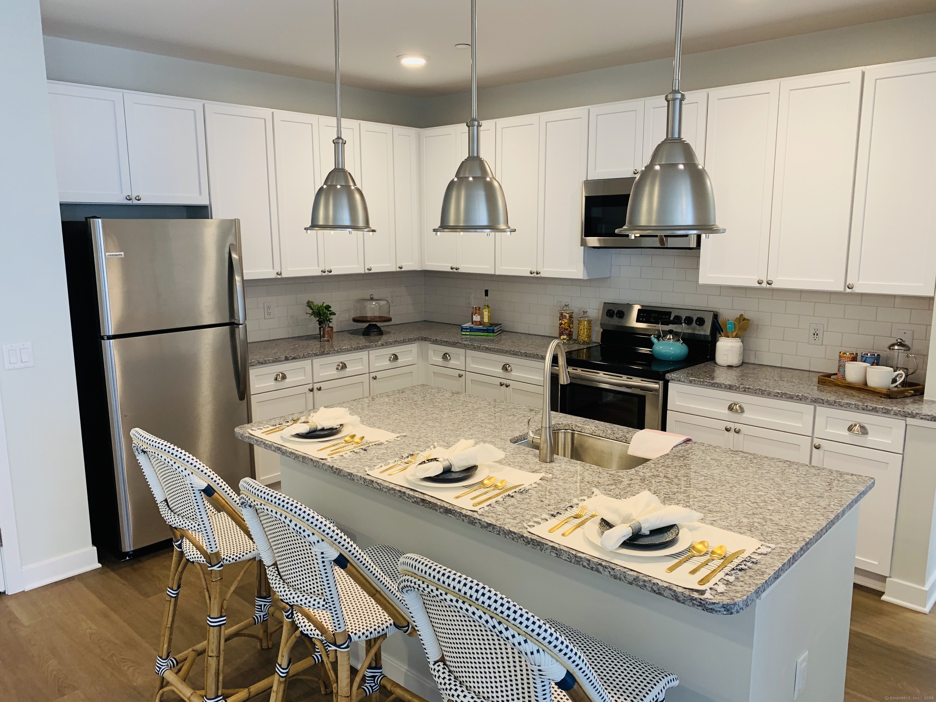 50 Perkins Farm Drive, Unit PH402 NEWPORT Stonington, CT 06355 - Photo 19 of 31 a kitchen with stainless steel appliances granite countertop a stove refrigerator sink and cabinets