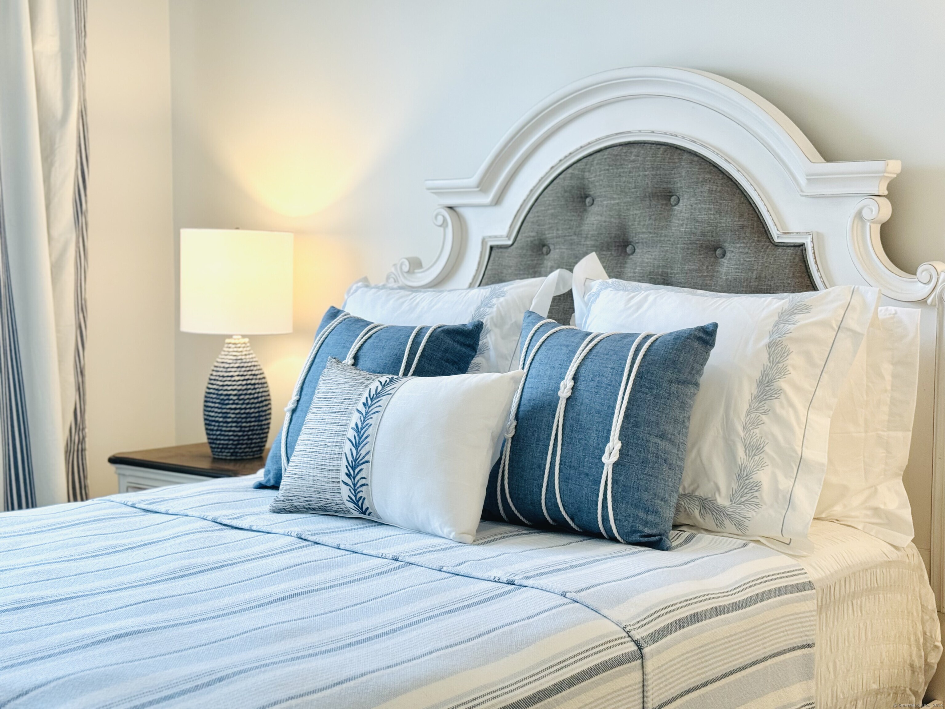 50 Perkins Farm Drive, Unit PH402 NEWPORT Stonington, CT 06355 - Photo 24 of 31 a bedroom with a bed and a mirror