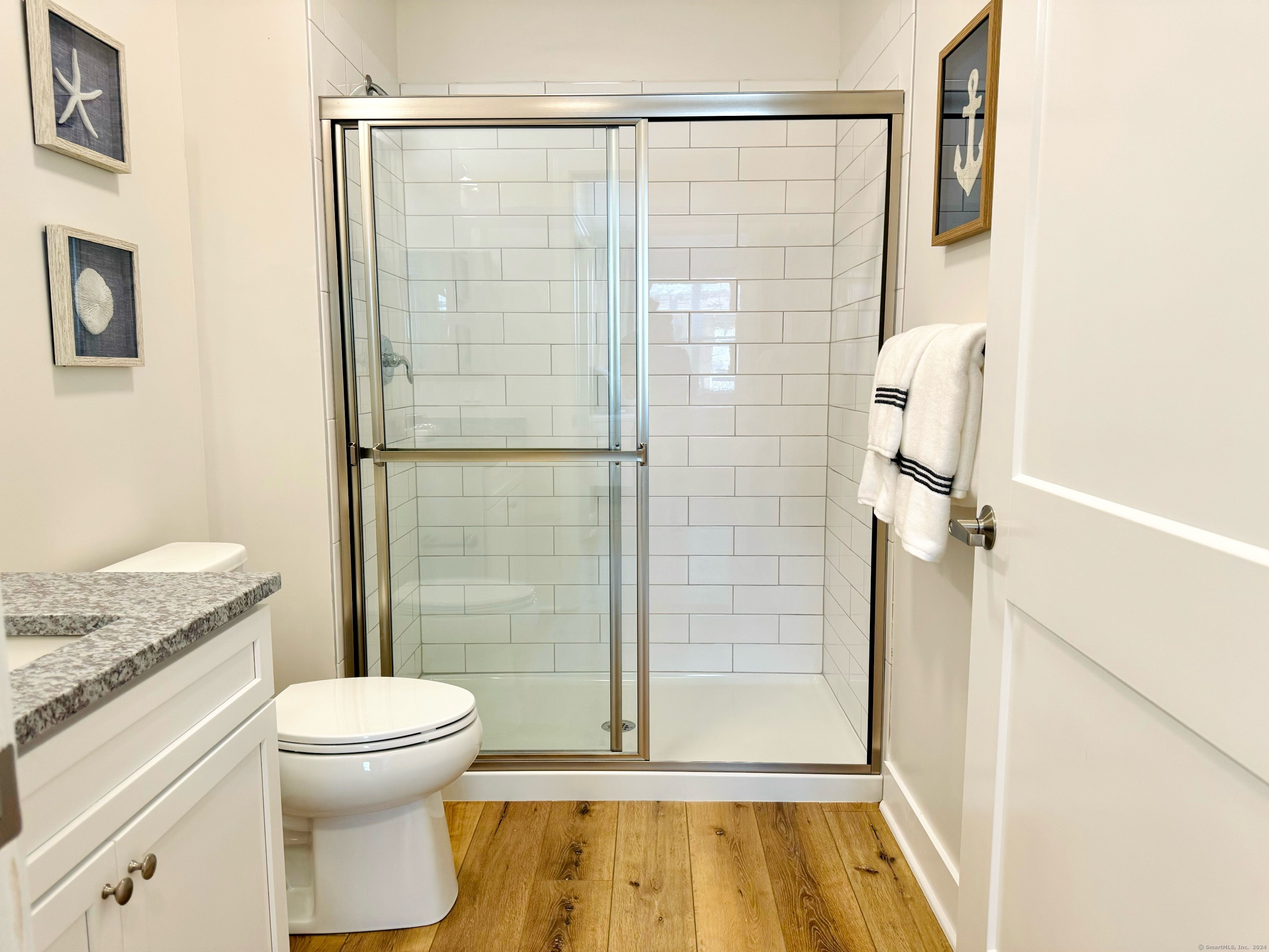 50 Perkins Farm Drive, Unit PH402 NEWPORT Stonington, CT 06355 - Photo 27 of 31 a bathroom with a granite countertop shower a toilet and a sink