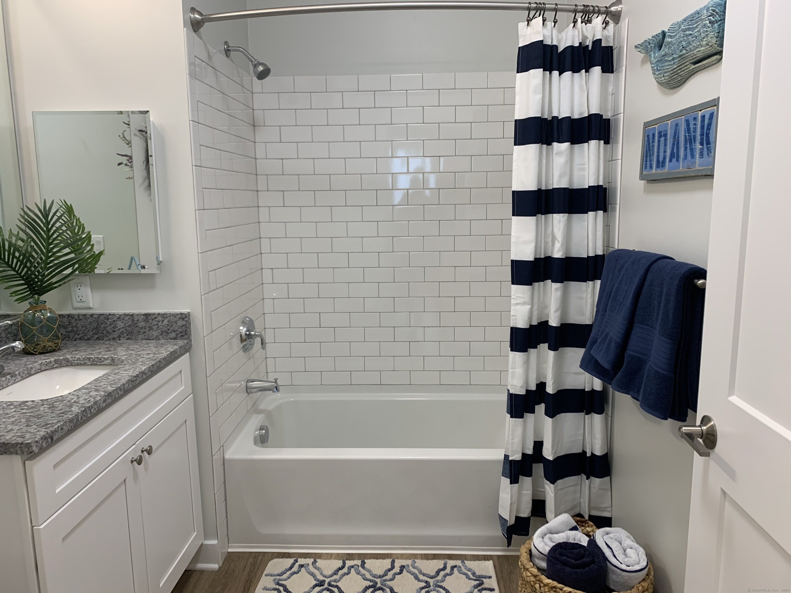 50 Perkins Farm Drive, Unit PH402 NEWPORT Stonington, CT 06355 - Photo 28 of 31 a bathroom with a granite countertop sink a toilet and shower