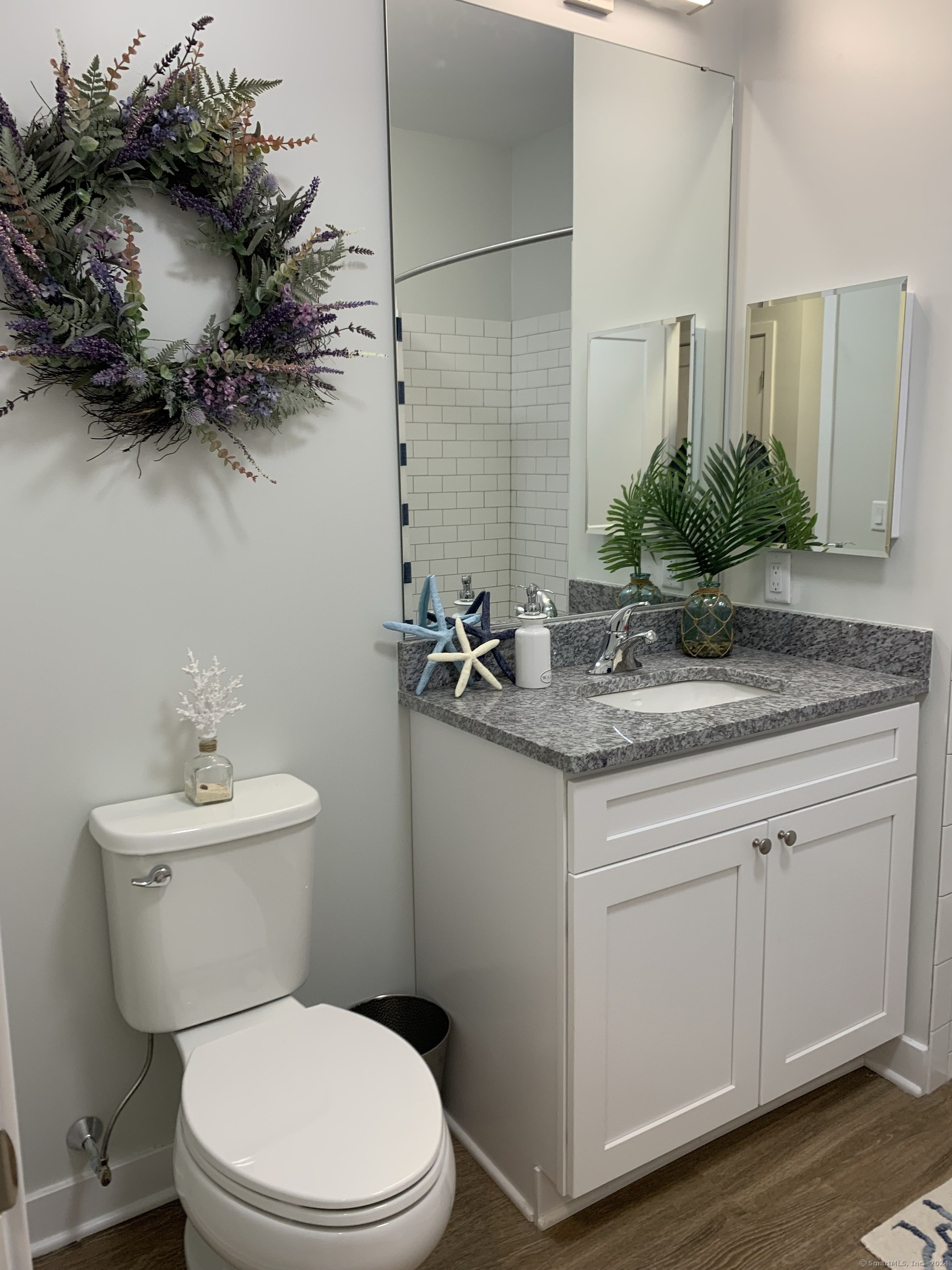 50 Perkins Farm Drive, Unit PH402 NEWPORT Stonington, CT 06355 - Photo 29 of 31 a bathroom with a granite countertop sink a toilet and mirror