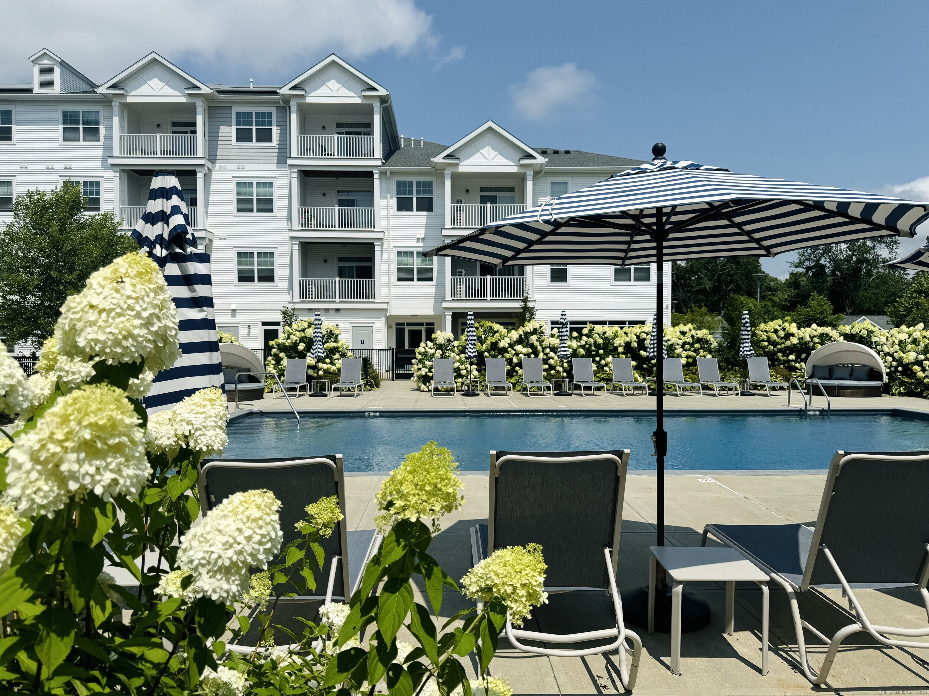 50 Perkins Farm Drive, Unit PH402 NEWPORT Stonington, CT 06355 - Photo 6 of 31 a front view of building and outdoor seating