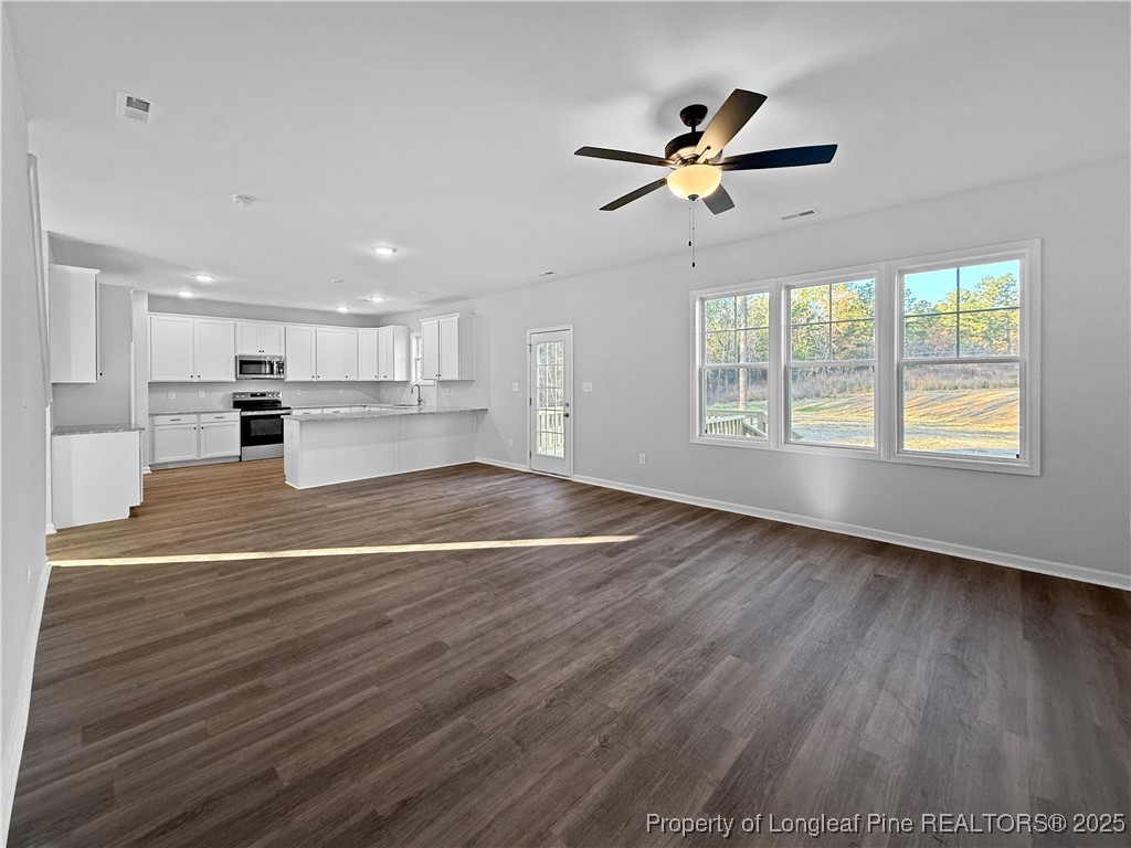 342 Flying Bolt Drive Raeford, NC 28376 - Photo 11 of 30 a view of an empty room with window and wooden floor