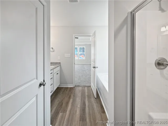 a view of a bathroom from a hallway