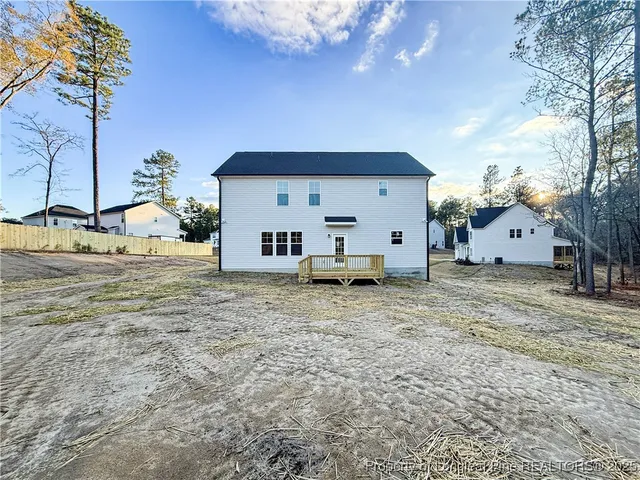 a view of a house with a backyard