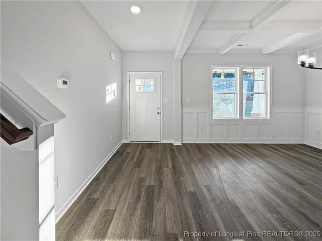 a view of a room with wooden floor and windows