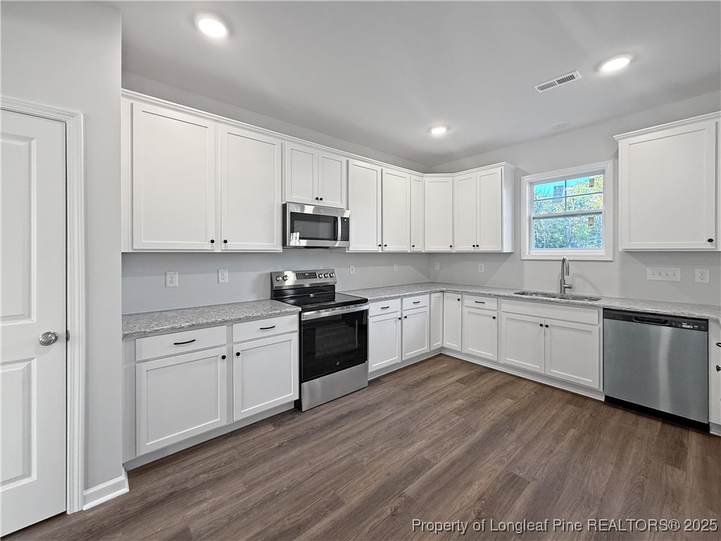 342 Flying Bolt Drive Raeford, NC 28376 - Photo 6 of 30 a kitchen with granite countertop white cabinets and white appliances