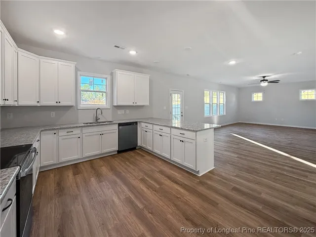 a large kitchen with stainless steel appliances granite countertop a large center island and a sink